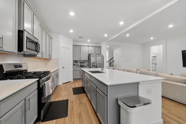 a kitchen with a sink stove and microwave