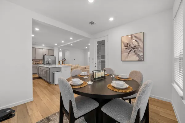 a view of a dining room with furniture and wooden floor