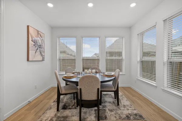 a dining room with furniture and window