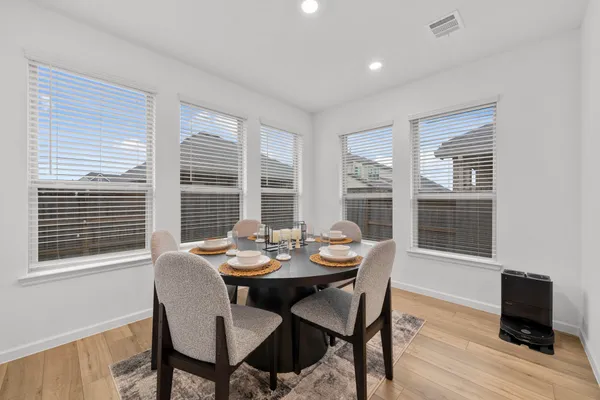 a dining room with furniture and window
