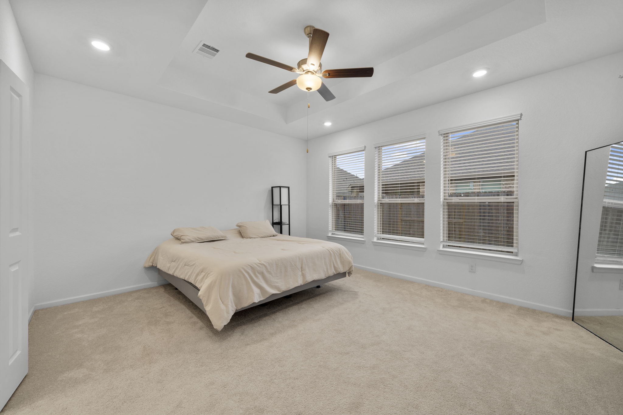 3704 Field Coast Lane Rosenberg, TX 77469 - Photo 21 of 49 Primary bedroom with tray ceiling and ceiling fan