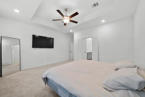 a bedroom with a bed and a flat screen tv