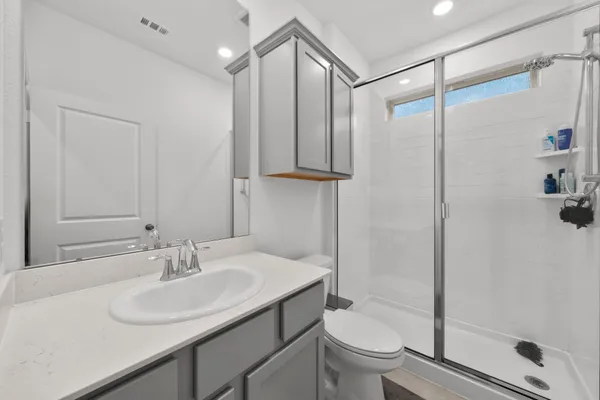 a bathroom with a sink toilet and shower