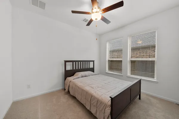 a bed sitting in a room next to a window