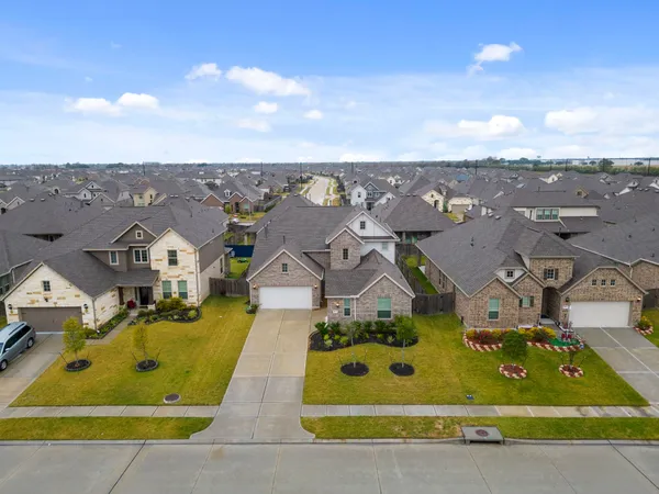 an aerial view of a house with a swimming pool