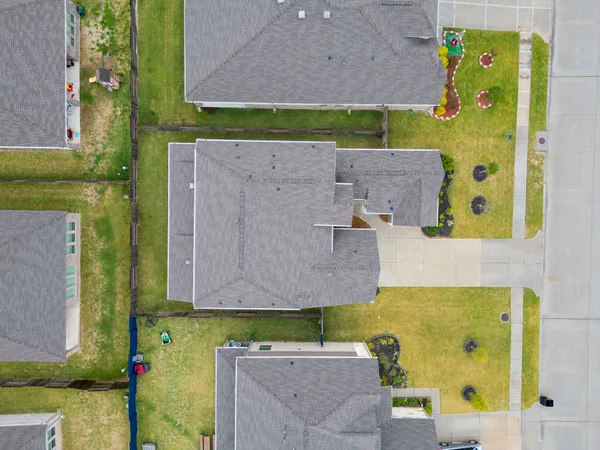 aerial view of a house with a yard