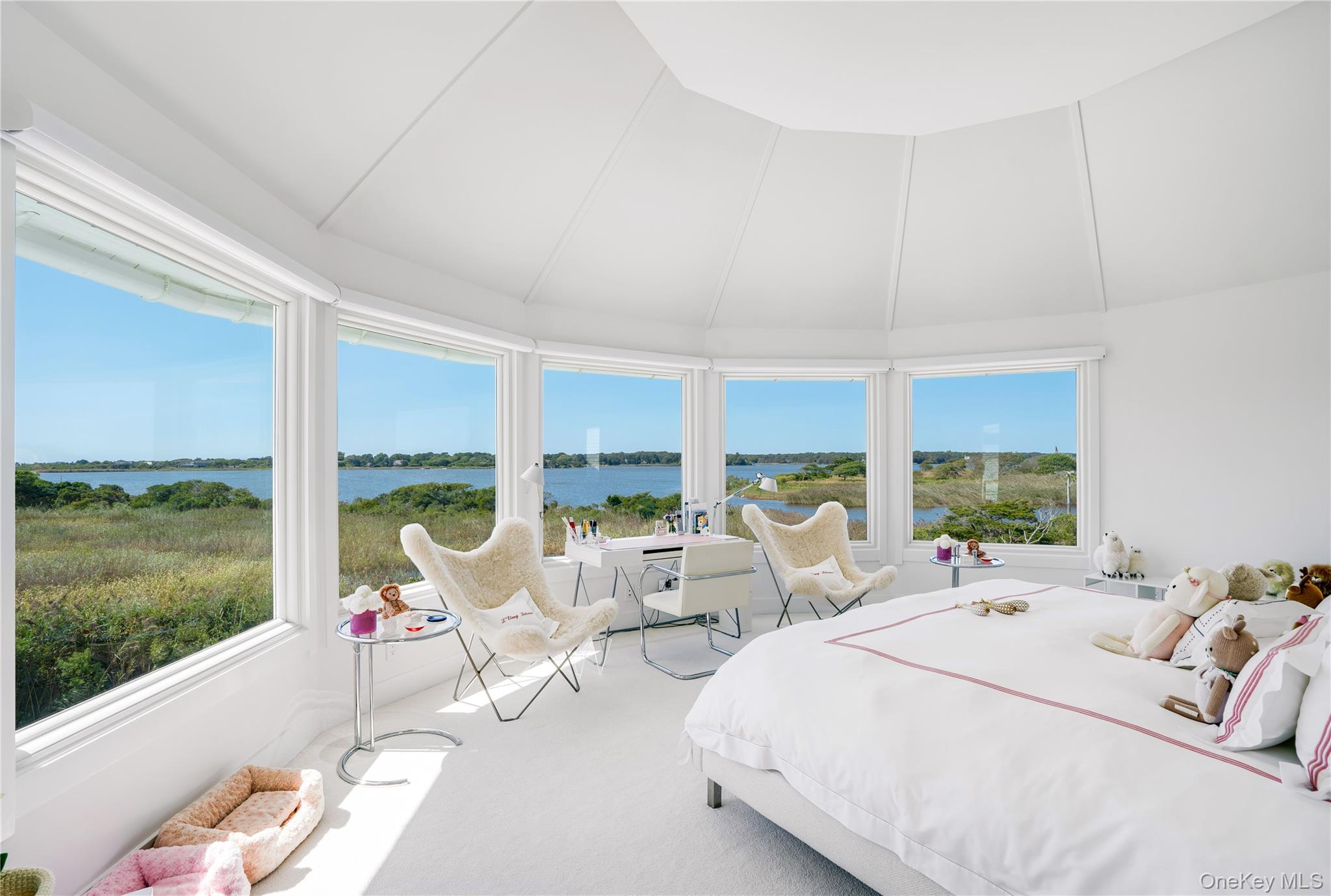 64 West End Road East Hampton, NY 11937 - Photo 15 of 33 a large bedroom with a bed and large windows