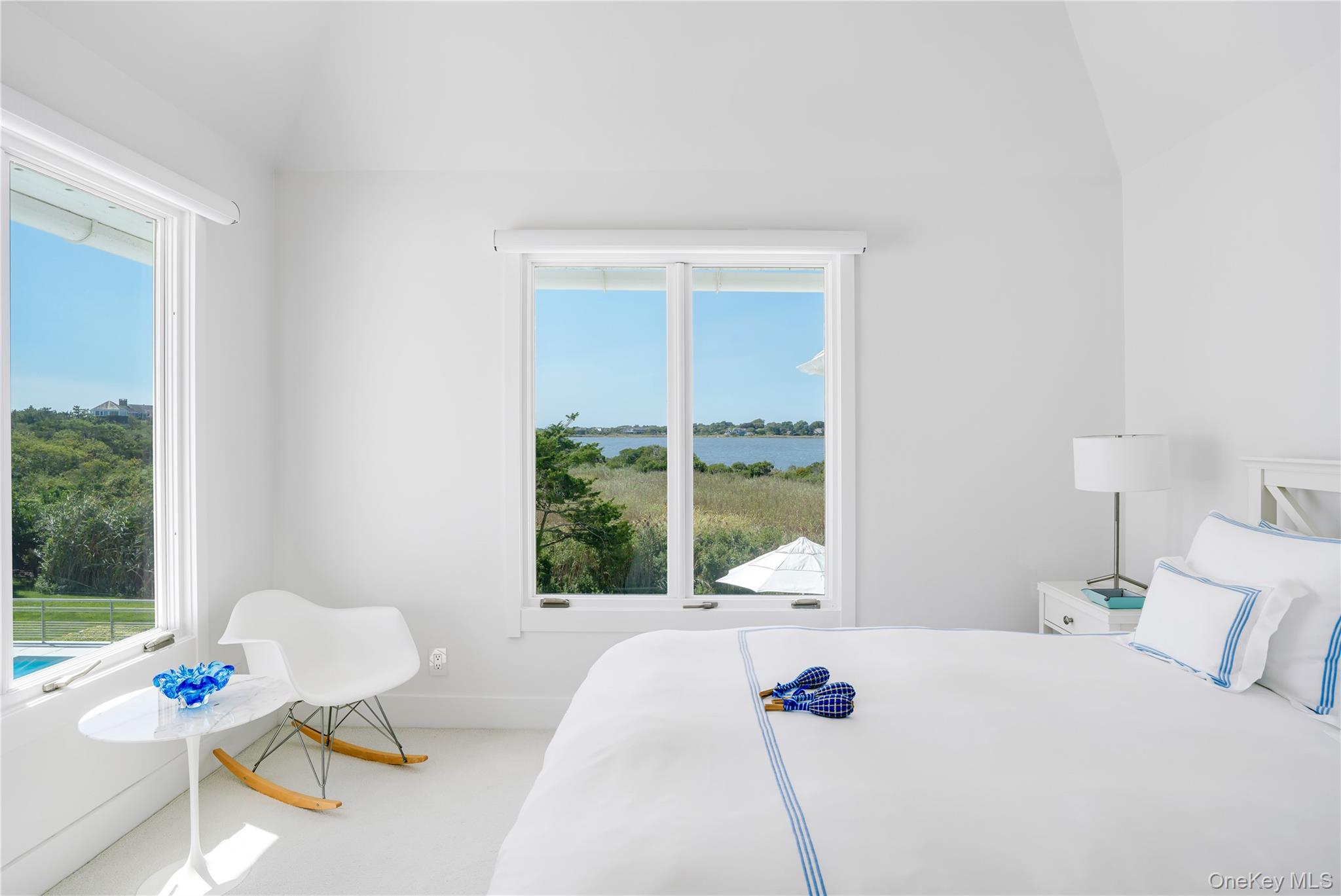 64 West End Road East Hampton, NY 11937 - Photo 17 of 33 a bed sitting in a bedroom next to a window