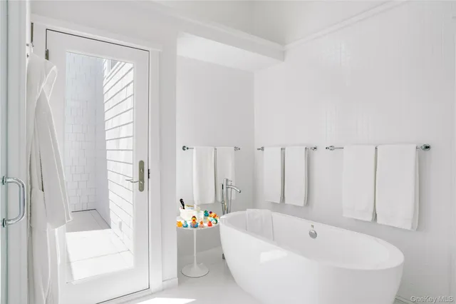 a bathroom with a tub and shower