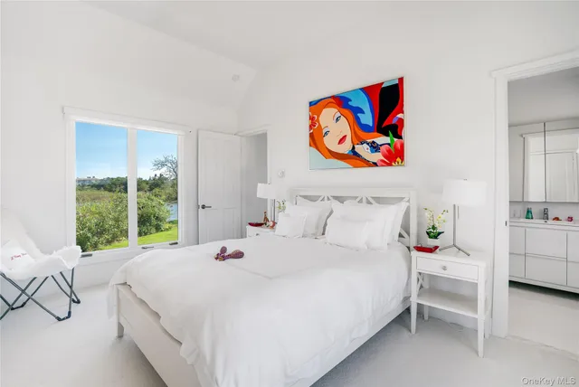 a bedroom with a bed a window and dresser