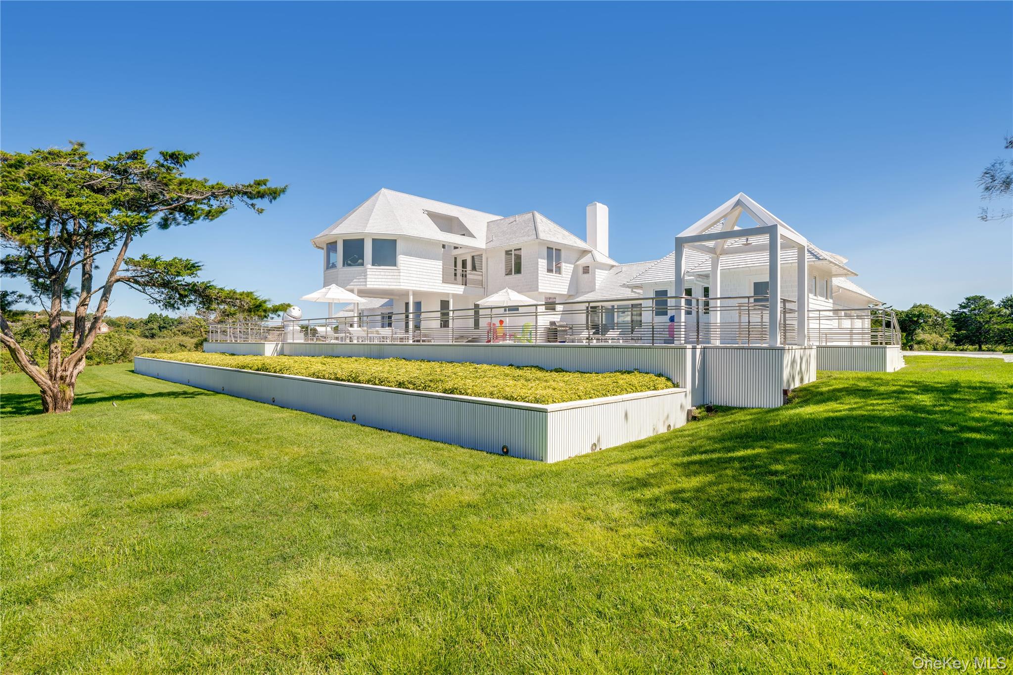 64 West End Road East Hampton, NY 11937 - Photo 26 of 33 a view of a house with swimming pool and a yard
