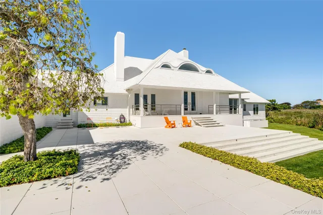 an aerial view of ocean with residential house and outdoor space