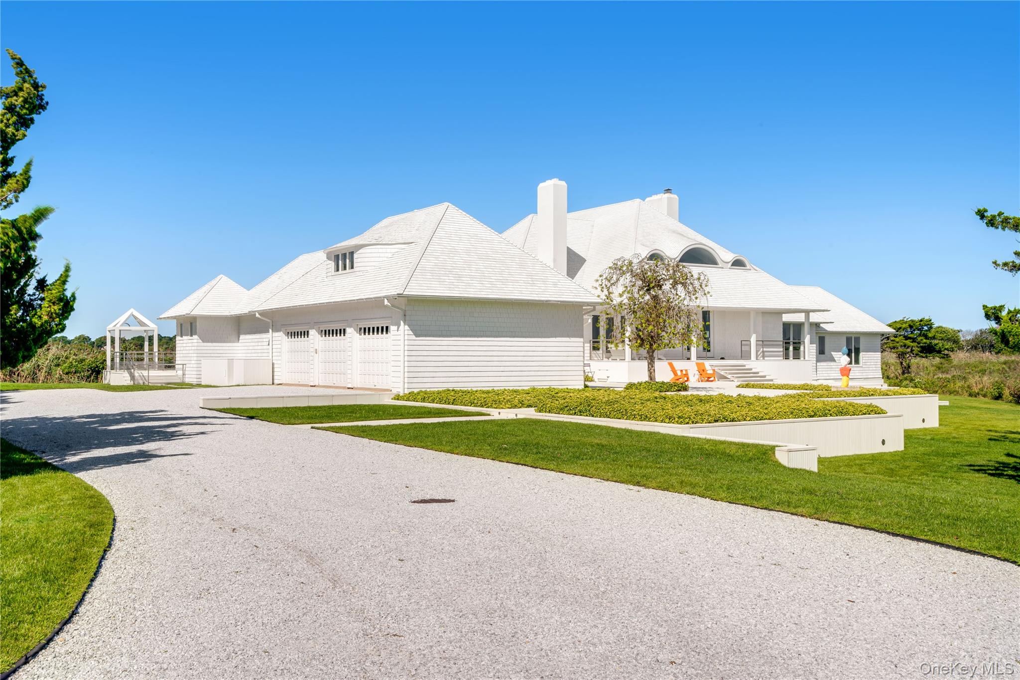 64 West End Road East Hampton, NY 11937 - Photo 29 of 33 a front view of a house with swimming pool having outdoor seating