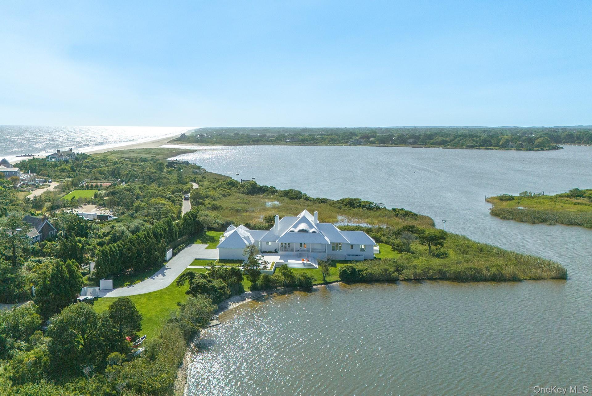 64 West End Road East Hampton, NY 11937 - Photo 3 of 33 a view of a lake with houses in the back