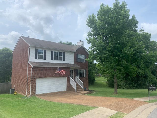 4002 Timber Ridge Court Mount Juliet, TN 37122 - Photo 1 of 37 a view of a house with a yard and a large tree