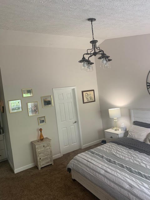 4002 Timber Ridge Court Mount Juliet, TN 37122 - Photo 17 of 37 a bedroom with a bed and a chandelier