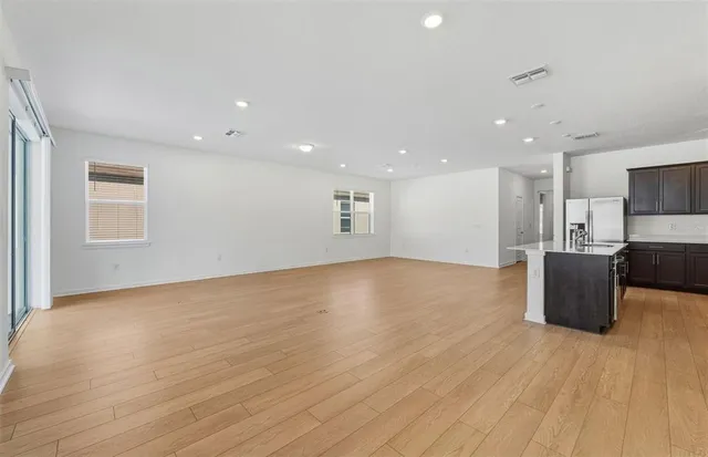 a view of kitchen with cabinets and wooden floor