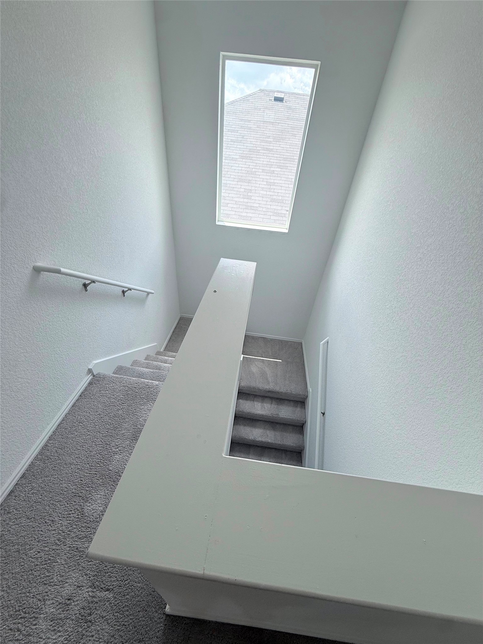 192 Rodney Boat Road Kyle, TX 78640 - Photo 31 of 40 Natural light floods this inviting staircase, enhancing the home's airy design.