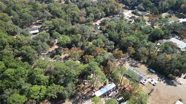 an aerial view of a houses with a yard