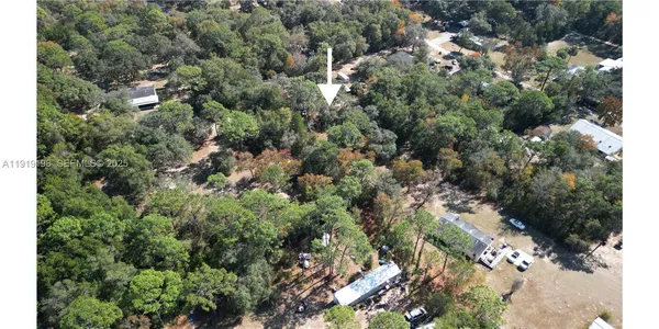 an aerial view of a residential houses with green space