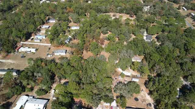 an aerial view of a houses with yard