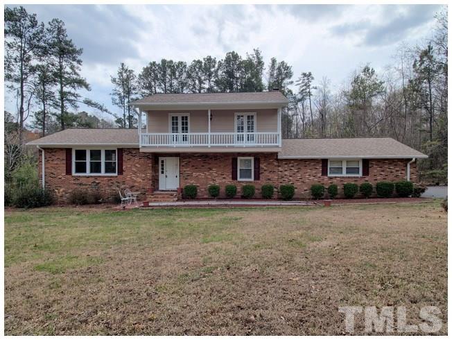 908 Orange Factory Road Bahama, NC 27503 - Photo 1 of 23 a front view of a house with garden