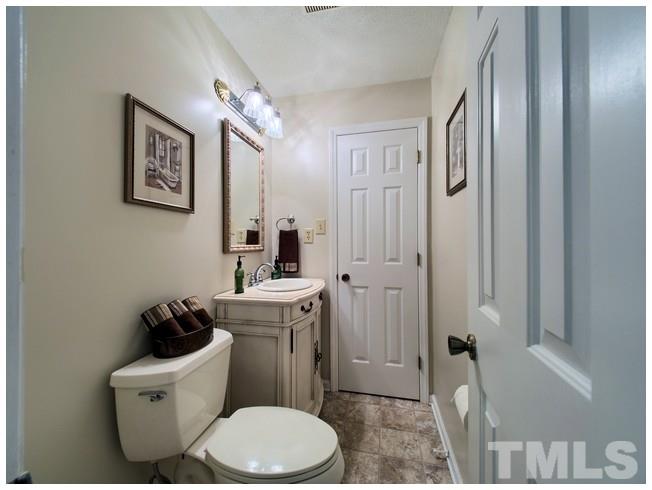 908 Orange Factory Road Bahama, NC 27503 - Photo 14 of 23 a bathroom with a toilet a sink and shower