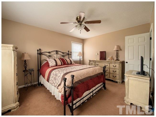 908 Orange Factory Road Bahama, NC 27503 - Photo 19 of 23 a bedroom with a bed and cabinets