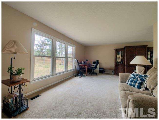 908 Orange Factory Road Bahama, NC 27503 - Photo 4 of 23 a living room with furniture and a large window