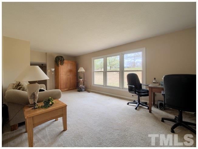 908 Orange Factory Road Bahama, NC 27503 - Photo 5 of 23 a livingroom with workspace and a window