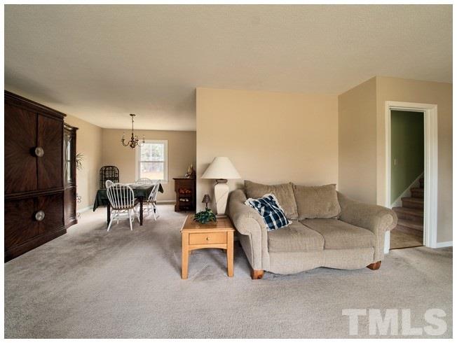 908 Orange Factory Road Bahama, NC 27503 - Photo 6 of 23 a living room with furniture and a flat screen tv