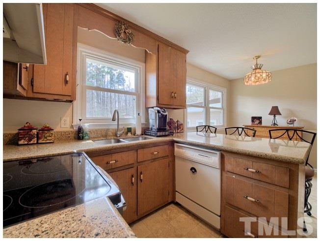 908 Orange Factory Road Bahama, NC 27503 - Photo 8 of 23 a kitchen with a sink cabinets and window
