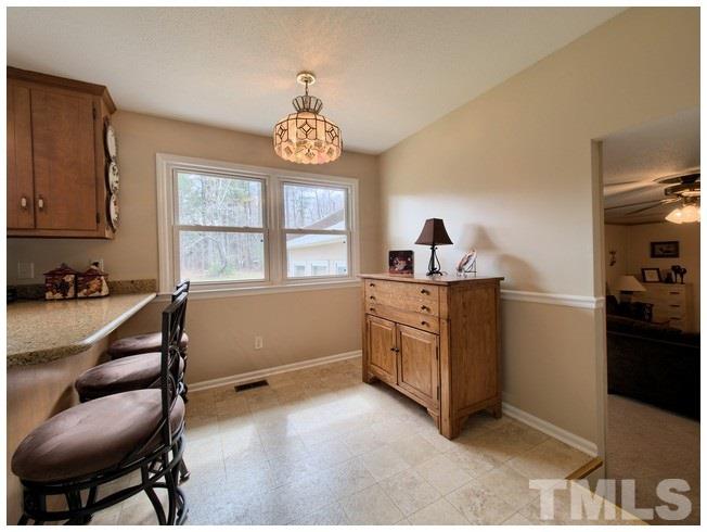 908 Orange Factory Road Bahama, NC 27503 - Photo 10 of 23 a kitchen with a refrigerator and a stove top oven