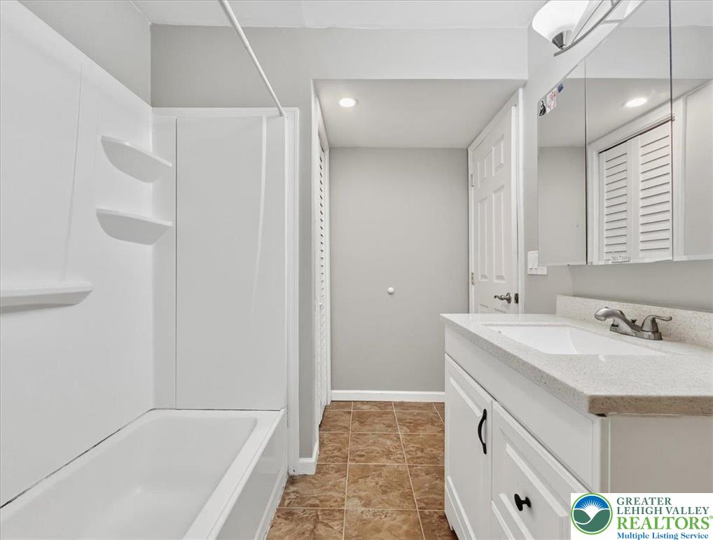 612 Mountain View Way Bushkill, PA 18324 - Photo 17 of 31 a bathroom with a tub sink and mirror