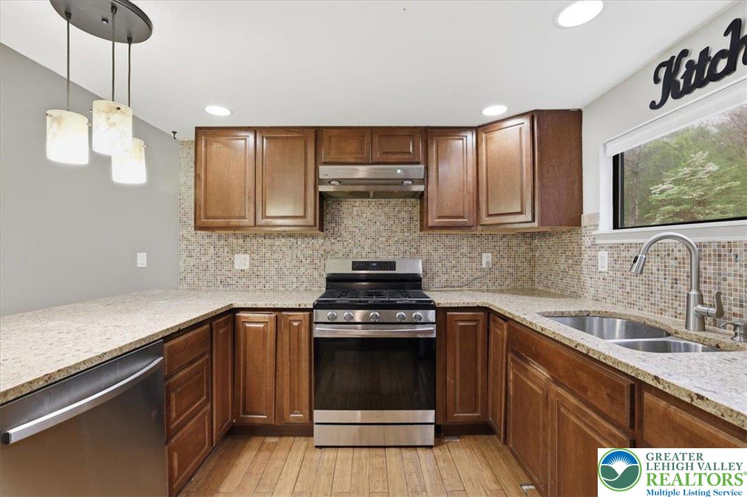 612 Mountain View Way Bushkill, PA 18324 - Photo 9 of 31 a kitchen with stainless steel appliances granite countertop a stove a sink and a microwave