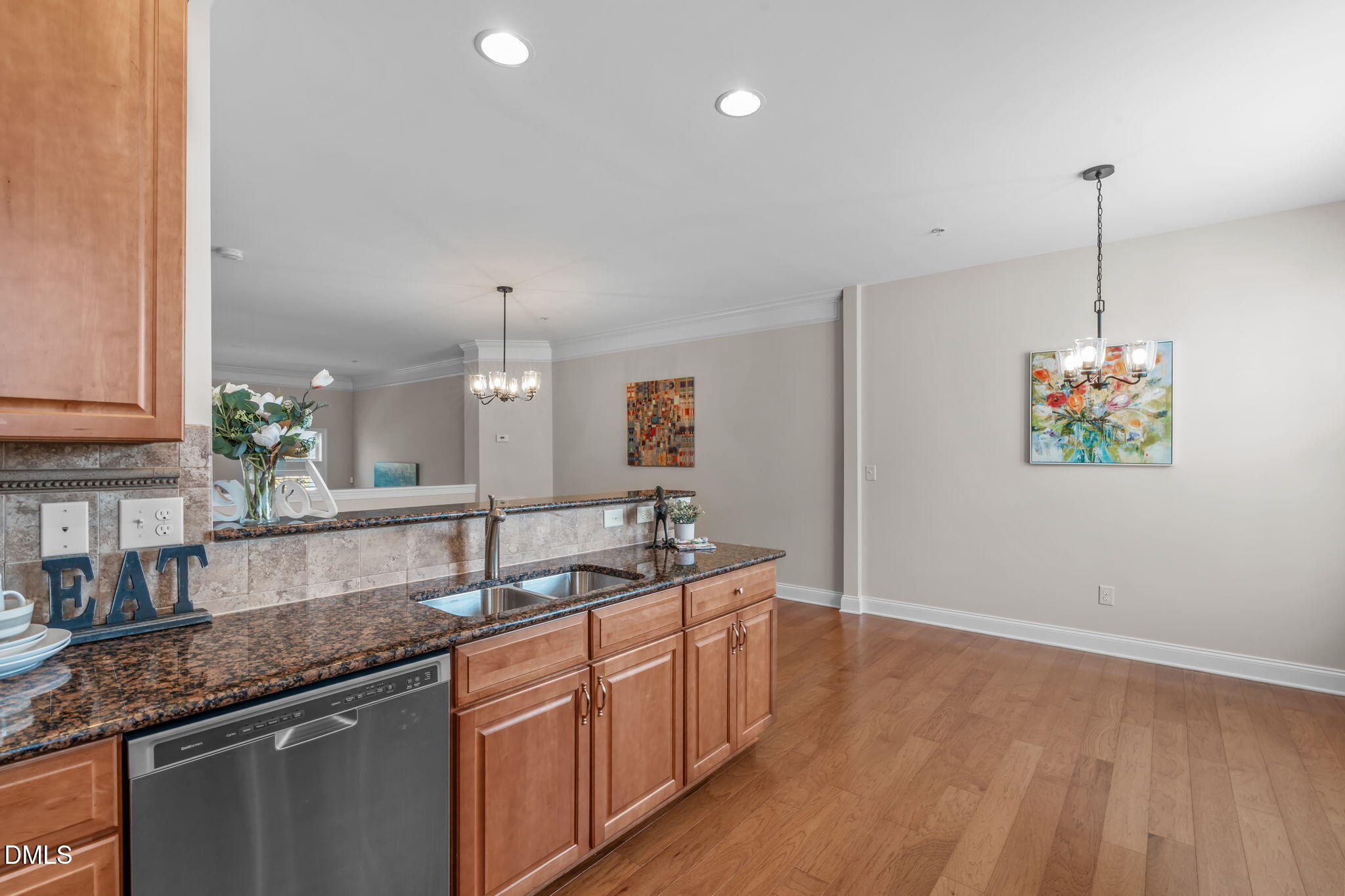 10410 Sablewood Drive, Unit 109 Raleigh, NC 27617 - Photo 12 of 42 a kitchen with granite countertop a sink and a wooden floor