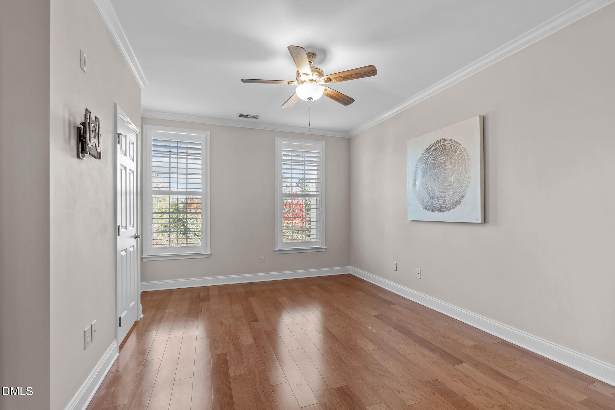 10410 Sablewood Drive, Unit 109 Raleigh, NC 27617 - Photo 18 of 42 a view of an empty room with wooden floor and a window