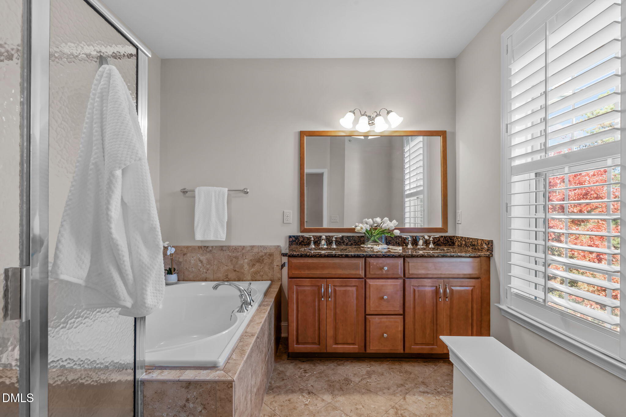 10410 Sablewood Drive, Unit 109 Raleigh, NC 27617 - Photo 20 of 42 a bathroom with a granite countertop sink and a mirror