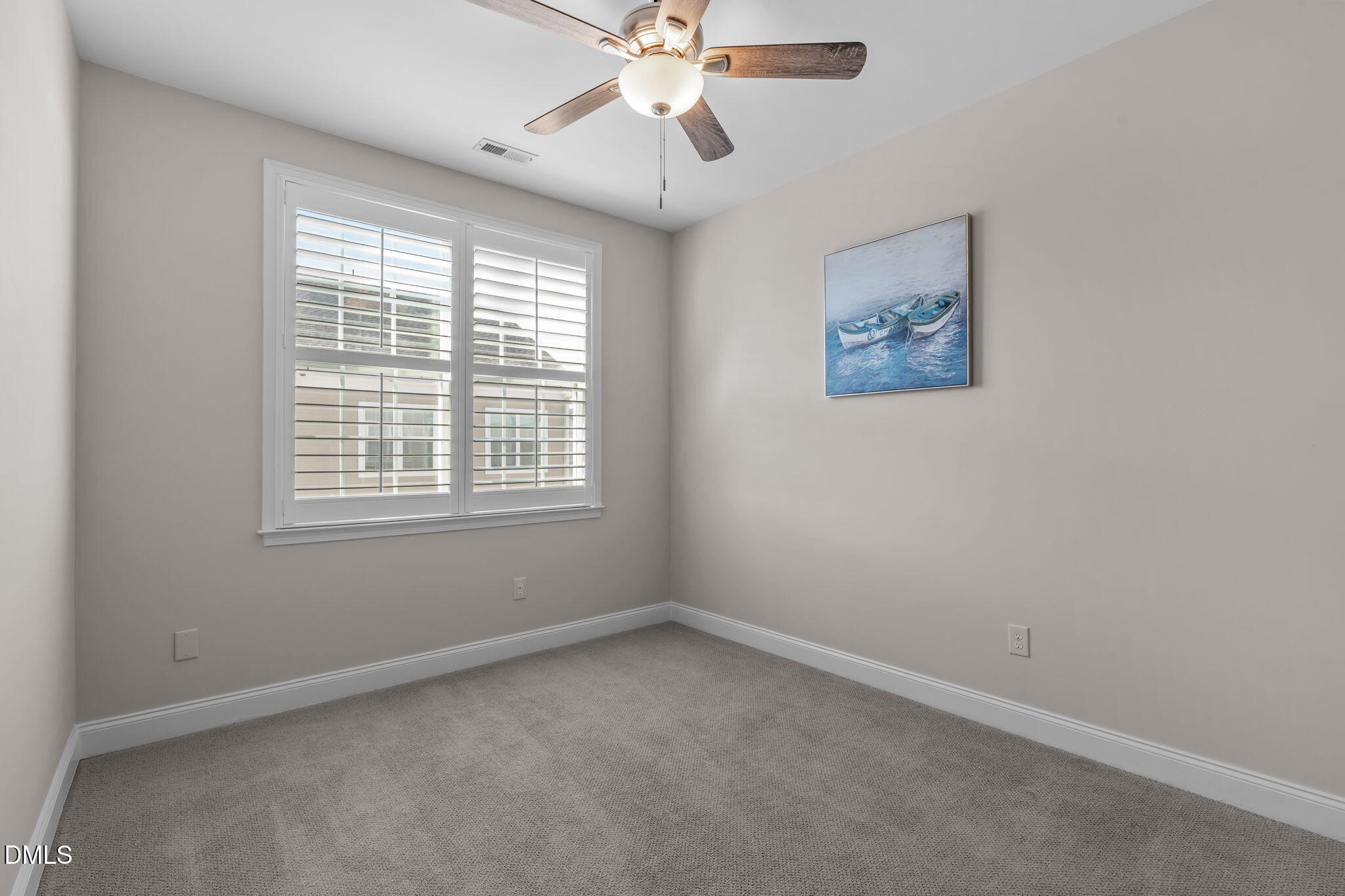 10410 Sablewood Drive, Unit 109 Raleigh, NC 27617 - Photo 23 of 42 an empty room with a window and a fan