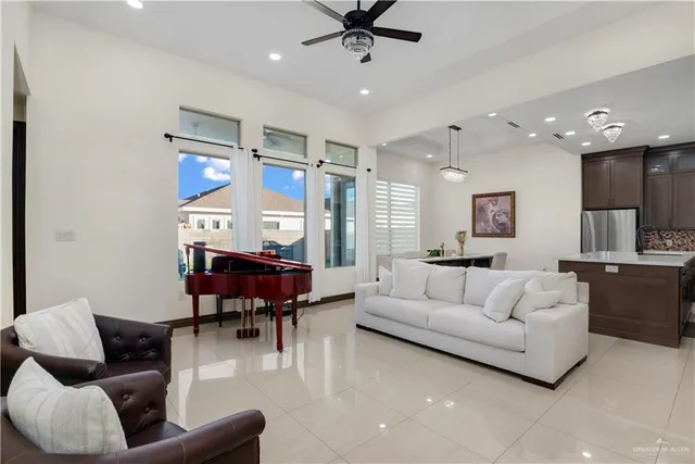a living room with furniture and kitchen view