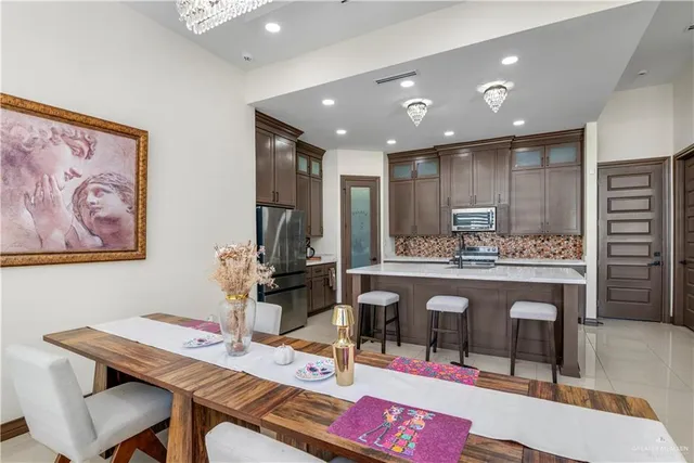 a large kitchen with a table and chairs in it