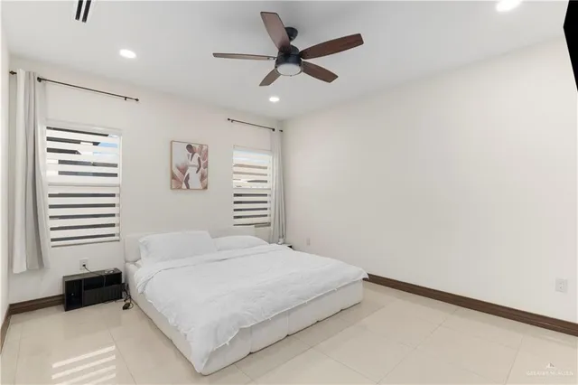 a bedroom with a bed and a ceiling fan
