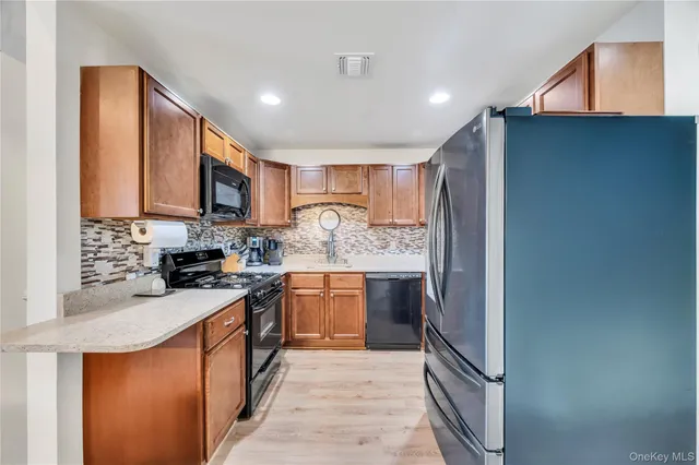 a kitchen with stainless steel appliances granite countertop a stove top oven a sink and dishwasher