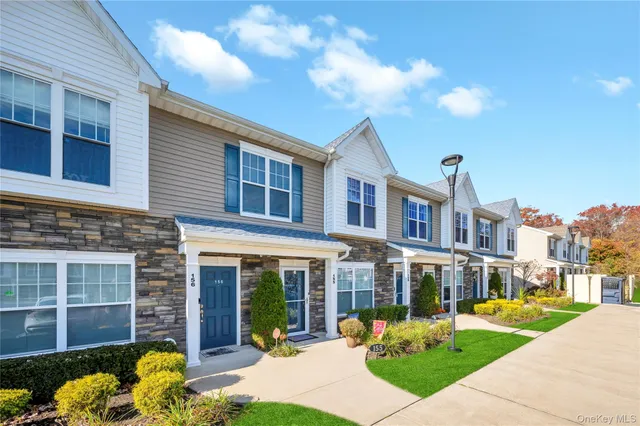 a front view of a building with garden and entertaining space