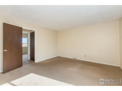 an empty room with wooden floor