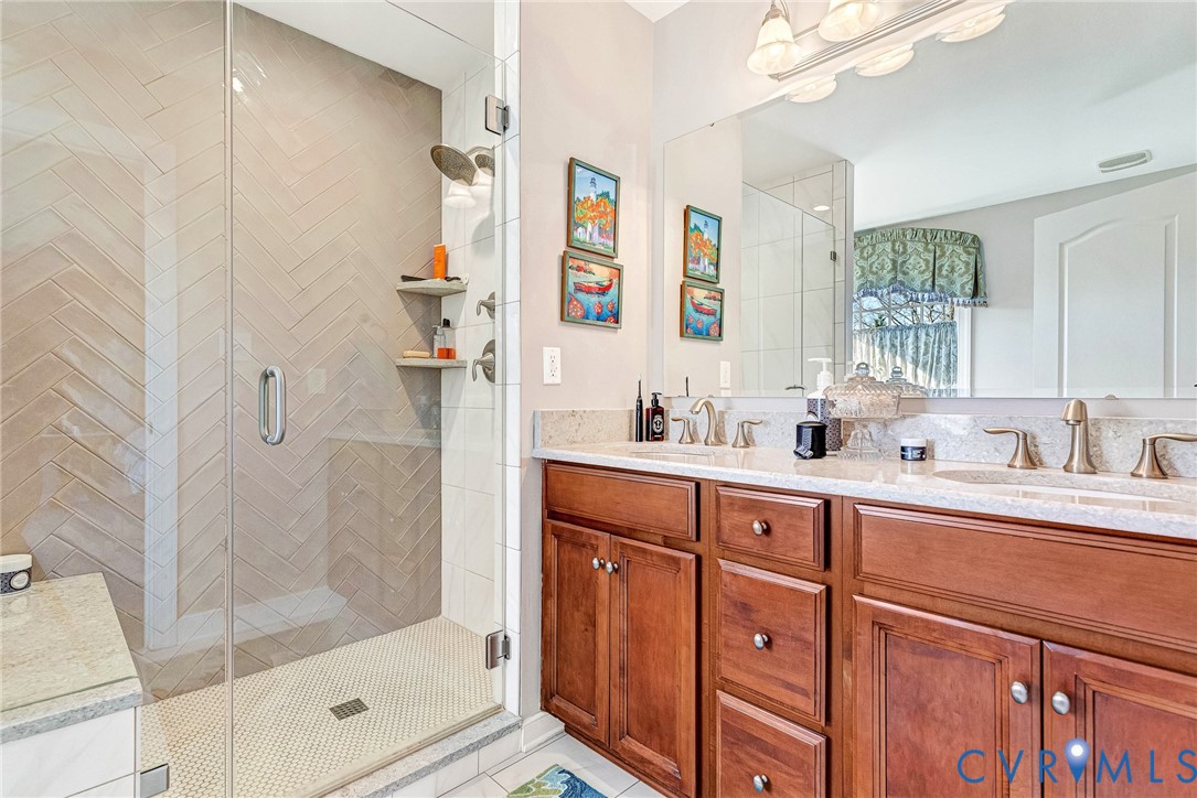 5221 Preston Square Loop Glen Allen, VA 23059 - Photo 22 of 30 a spacious bathroom with double vanity a mirror and shower