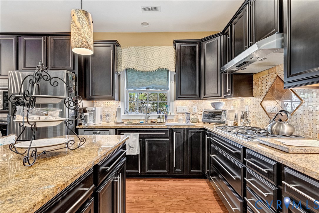 5221 Preston Square Loop Glen Allen, VA 23059 - Photo 3 of 30 a kitchen with stainless steel appliances granite countertop a sink and stove