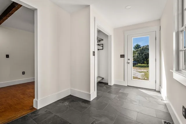 an empty room with windows and closet