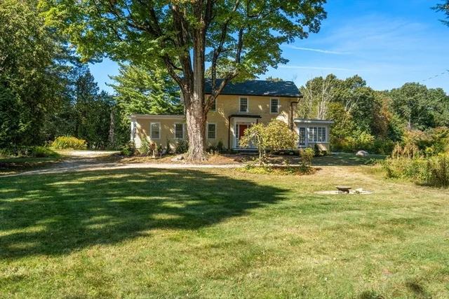 a front view of a house with garden