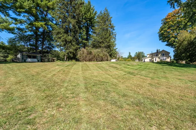 a view of a field with an trees in the background